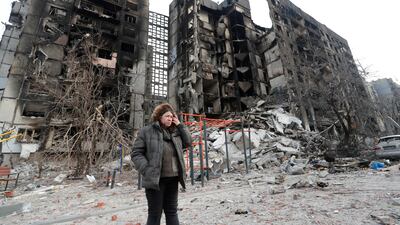 Nurse Svetlana Savchenko, 56, stands next to her bombed-out apartment building in the besieged southern port city of Mariupol, Ukraine, on March 30. Reuters