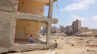 A volunteer rests inside a destroyed home. Reuters