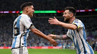 Nahuel Molina celebrates with Lionel Messi after scoring for Argentina. Getty