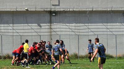 Players of the 'La Drola' rugby union team play against visiting Biella at the Lorusso e Cutugno penitentiary near Turin. Gabriel Bouys / AFP