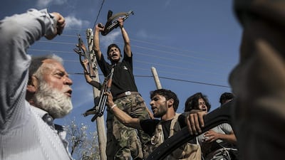 In Syria's Idlib province, an Al Qaeda linked group is attempting to lure Isil fighters into its ranks. AP Photo