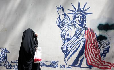 A woman passes an anti-US mural in Tehran, Iran. EPA