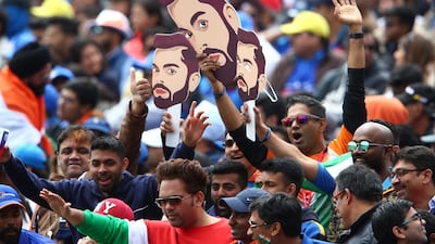 Indian cricket fans wear masks of India's captain Virat Kohli during the match. AP Photo