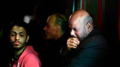 A man reacts as he stands near the body of the suicide bomber. AFP