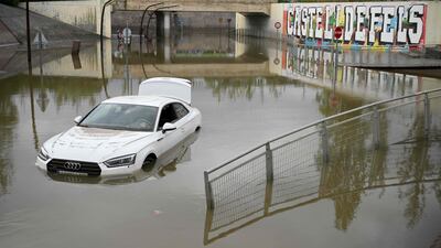 A car stranded in flood waters in the Barcelona suburb of Castelldefels after torrential rain struck Catalonia. AFP