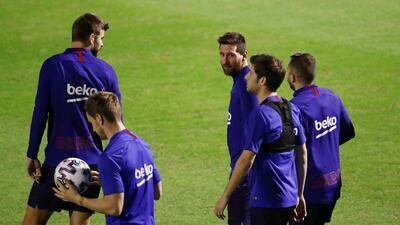 Lionel Messi with his Barcelona teammates. Reuters