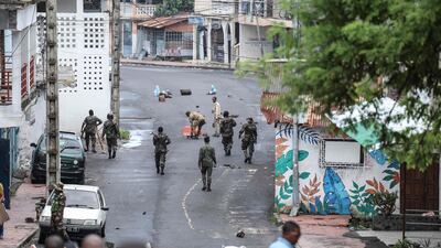 Comoros soldiers clear barricades placed by opposition protesters in Moroni. Former coup leader Azali Assoumani won re-election in the first round of a disputed presidential vote in the Comoros, an Indian Ocean island chain. AFP
