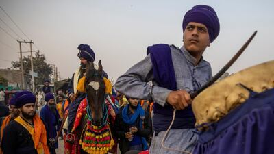 A group of Nihangs (Sikh warriors) arrive to take part in a protest against the newly passed farm bills at Singhu border near Delhi, India. Reuters
