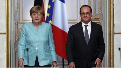 French president Francois Hollande and German chancellor Angela Merkel arrive for a press conference after their meeting at the Elysee Palace on July 06, 2015. Thierry Chesnot / Getty Images