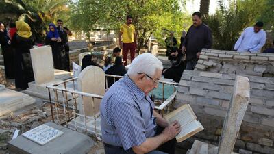 Iraqis gather around the graves of relatives on the first day of the Eid Al Adha holiday in the capital Baghdad. AFP