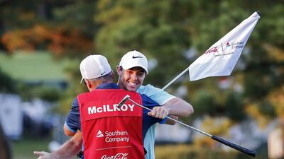 Rory McIlroy of Northern Ireland hugs his caddie JP Fitzgerald on the sixteenth green after McIlroy won the Tour Championship golf tournament on the fourth play-off hole. Erik Lesser / EPA