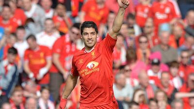 Liverpool's Uruguayan striker Luis Suarez celebrates scoring his team's second goal during the English Premier League football match between Liverpool and Tottenham Hotspur at Anfield in Liverpool, northwest England on March 30, 2014. Paul Ellis / AFP PHOTO