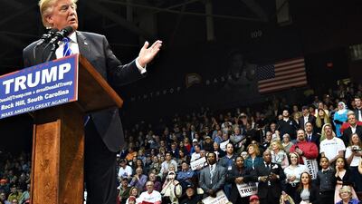 Republican presidential candidate Donald Trump was speaking during a campaign stop at Winthrop University on Friday, January 8, 2016, in Rock Hill, South Carolina when a Muslim woman, wearing a white head scarf and a blue T-shirt emblazoned with the words, “Salam, I come in peace”, stood up in the stands directly behind him in a silent protest, prompting security officers to eject her from the meeting. Rainier Ehrhardt/AP Photo
