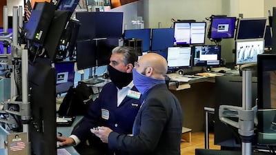 Traders wearing masks work on the floor at the New York Stock Exchange. The big tech stocks – Amazon, Apple, Google-owner Alphabet, Microsoft, Facebook and Netflix - benefited from the pandemic but they may have overreached themselves, say analysts. Reuters