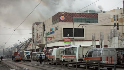 Smoke rises above a multi-story shopping centre in the Siberian city of Kemerovo. Sergei Gavrilenko / AP Photo