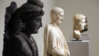 A view of ancient sculptures, one of a Bodhisattva from Pakistan, left, dating back to the 2nd-3rd century and one of a Roman Togatus from the 2nd century. Francois Guillot/AFP