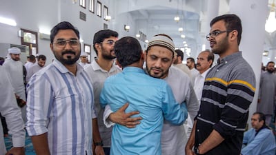 Greeting friends and relatives after morning Eid prayers at Zayed the Second Mosque in Abu Dhabi. Victor Besa / The National