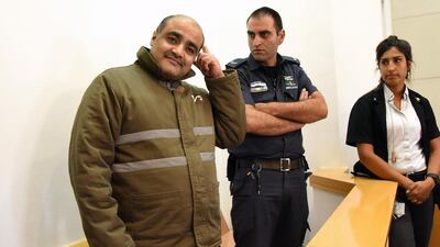 Palestinian Mohammed Al Halabi (L), the Gaza director of World Vision looks on during his indictment at a district court in the southern Israeli city of Beersheva on August 4, 2016. Dudu Grunshpan/AFP