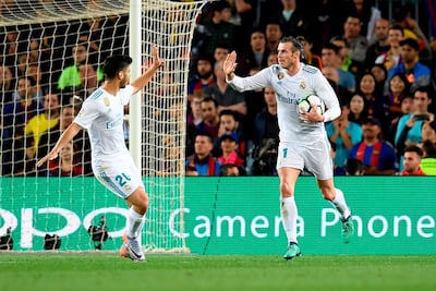 Real Madrid's Welsh forward Gareth Bale, right, celebrates with teammate Marco Asensio after scoring a late equaliser against Barcelona at Camp Nou. Lluis Gene / AFP