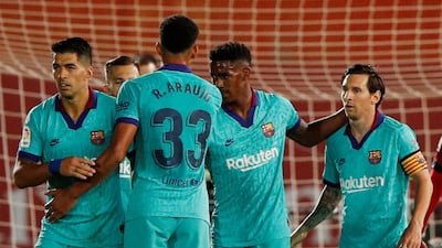 Barcelona players celebrate Lionel Messi scoring their fourth but there are no spectators to appreciate it. Reuters