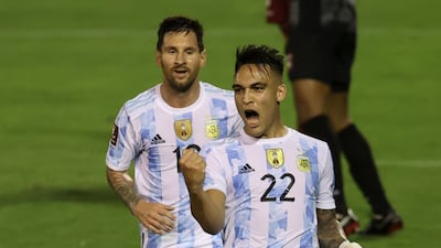 Lautaro Martinez, right, celebrates scoring the opening goal for Argentina against Venezuela beside teammate Lionel Messi. AP
