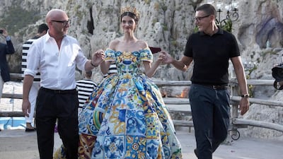Domenico Dolce, left, and Stefano Gabbana, right, escort a model. Courtesy Matt Lever / James Cochcrane