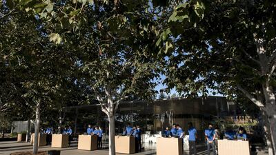 Employees wait for attendees ahead of the Apple event. Bloomberg