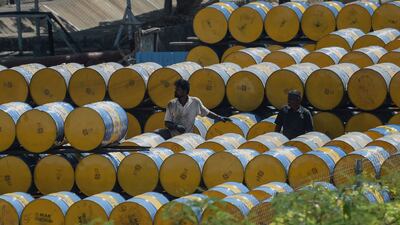 A worker stacks oil barrels at a filling station in Chennai. The latest surge in oil prices after Russian troops entered Ukraine could slow down India's economic recovery. AFP
