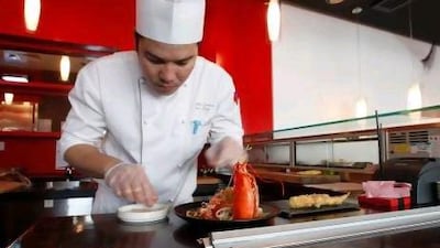 Leonardo Lanuza of Honyaki prepares Canadian lobster tempura with udon noodle salad. Jeffrey E Biteng / The National