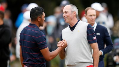 Matt Kuchar and Tony Finau celebrate on the 17th green during Saturday afternoon foursomes. Getty