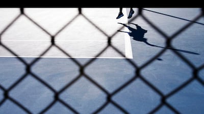 Heather Watson casts a shadow as she serves to Alexandra Cadantu during their women's singles match at the Australian Open tennis tournament in Melbourne. Tim Wimborne / Reuters