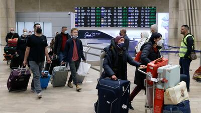 Passengers arrive at Israel's international airport near Tel Aviv on March 1, 2022. AFP