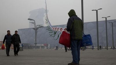In this picture taken February 23, 2014, a street vendor flies kites printed with the Beijing Olympic games mascot image near the Water Cube aquatic center in Beijing, China. The Water Cube, where U.S. swimmer Michael Phelps made history by winning eight gold medals, has been transformed into a water park popular among local families. Its operators even peddle purified glacier water under the Water Cube brand for additional income. Beijing, which spent more than $2 billion to build 31 venues for the 2008 Summer Games, is reaping some income and tourism benefits from two flagship venues, though many sites need government subsidies to meet hefty operation and maintenance costs. Ng Han Guan / AP Photo