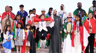 Sheikh Mohammed bin Rashid, Vice President and Ruler of Dubai, with Mayar Mohammed, the winner of this year's Arab Reading Challenge. Chris Whiteoak / The National