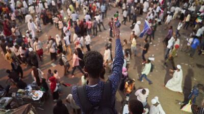 A protester chants and raises the peace sign. Getty Images