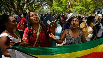 Zimbabweans gather to pray for the country in a park opposite the parliament building in Harare on Tuesday, Nov. 21, 2017. AP Photo/Ben Curtis