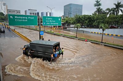 A military lorry drives through water on a flooded toll road following heavy rain in Jakarta, Indonesia. AP