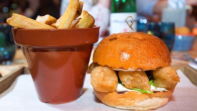 The menu features a mix of international favourites that conjure a sense of nostalgia - like this fish finger sandwich with chips. Leslie Pableo / The National