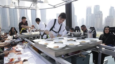 Senior chef from the Ritz Carlton, Elgin Alonso, prepares the brunch meal for serving alongside his colleagues during Dinner in the Sky over Dubai. Jeffrey E Biteng / The National