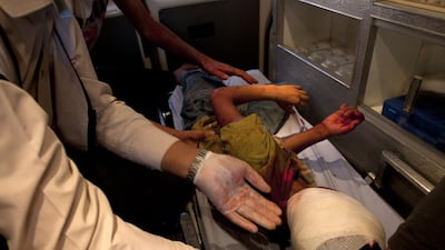 Bassam Ali Sayma, a paramedic that works for Gaza’s Red Crescent, treats an injured boy in an ambulance as they travel to Shifa Hospital in Gaza City on July 11,2014. The child suffered shrapnel wounds from an Israeli air strike near his home Gaza City. Heidi Levine for The National