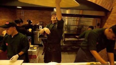 A chef prepares a pizza at Russo's New York Pizzeria in Dubai. The Texas chain intends to open several more outlets in the UAE. Jaime Puebla / The National