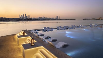 Perch on sun loungers immersed in water at White Dubai in Atlantis, The Palm, Dubai.