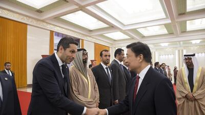 Sheikh Mohammed bin Zayed, Crown Prince of Abu Dhabi and Deputy Supreme Commander of the Armed Forces, looks on as Khaldoon Al Mubarak, chief executive of Mubadala Development Company and Chairman of the Abu Dhabi Executive Affairs Authority, greets Chinese vice president Li Yuanchao at the Great Hall of the People in Beijing on Monday. Mohamed Al Hammadi / Crown Prince Court – Abu Dhabi