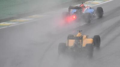 Manor Racing’s Pascal Wehrlein powers his car ahead of Renault’s Kevin Magnussen. Nelson Almeida / AFP