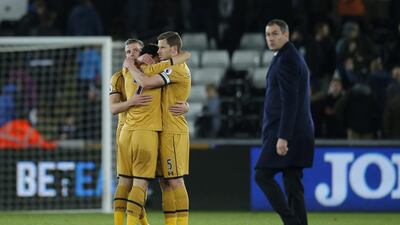 Tottenham's Toby Alderweireld, Son Heung-min and Jan Vertonghen celebrate as Swansea City manager Paul Clement looks dejected. Andrew Couldridge / Reuters