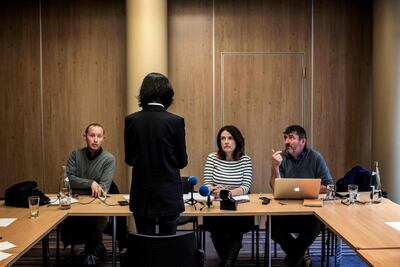 The wife of missing Interpol president Meng Hongwei, standing, talks to journalists in Lyon on October 7, 2018. AFP