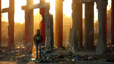 A Palestinian boy stands amidst the ruins of a building destroyed during the 50-day war between Israel and Hamas militants during the summer of 2014 in Beit Hanun, in the northern Gaza Strip. The World Bank said in a September report that just 10.7 percent of the 11,000 houses that were totally destroyed in 2014 had so far been rebuilt and about 50 percent of partially and severely damaged houses are still awaiting repair. Mohammed Abed / AFP