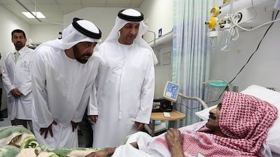 Dr Abdullah Al Nuaimi, director of the Ras Al Khaimah Medical District, right, and FNC member Salem Al Ameri speak to one of the patients at Hamad Obaidullah Hospital for the Elderly. The FNC’s health committee is on a tour of healthcare centres. Satish Kumar / The National
