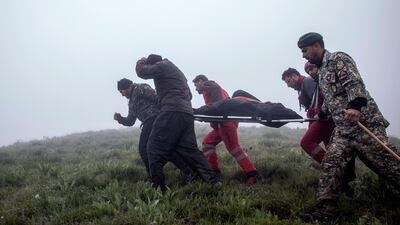 Rrescuers recover bodies at the crash site of in Varzaghan in north-western Iran. AFP