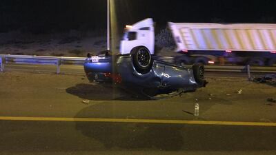 A man was seriously injured and another sustained minor injuries when their vehicle flipped on Emirates road toward Abu Dhabi on Sunday. Courtesy: Dubai Police